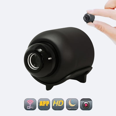 Black security camera with a hand holding a smaller camera lens on a white background