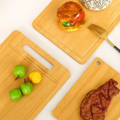 Three wooden cutting boards with food items on a white background