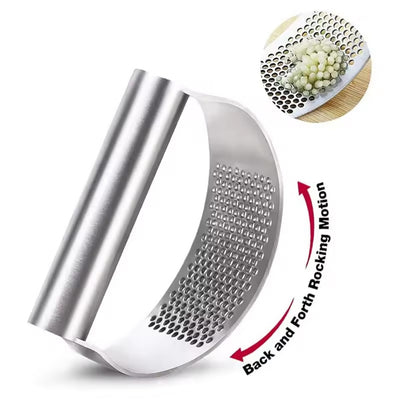 Metal garlic press with a close-up of grated garlic on a white background